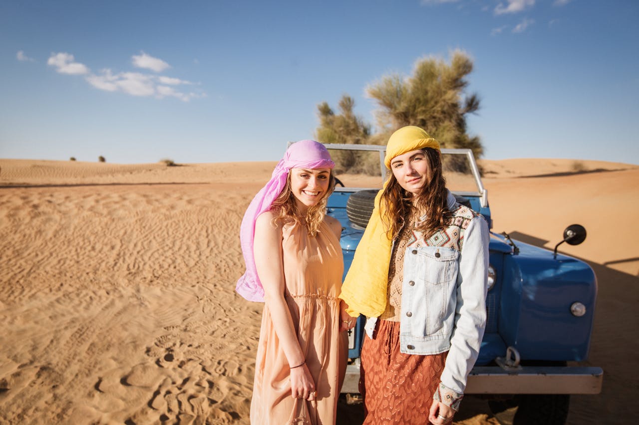 Tourists enjoying desert safari activities in appropriate clothing